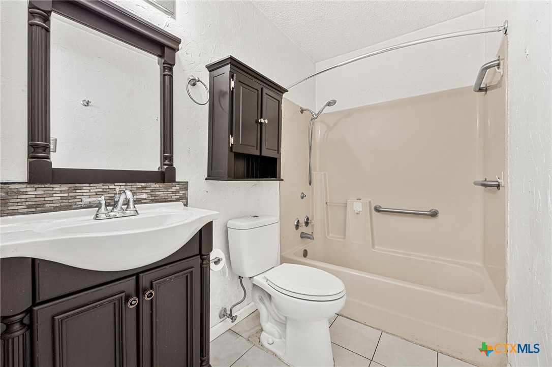1015 Old Mill Road, Unit 4D Salado, TX 76571 - Photo 15 of 22 a bathroom with a sink a toilet and shower