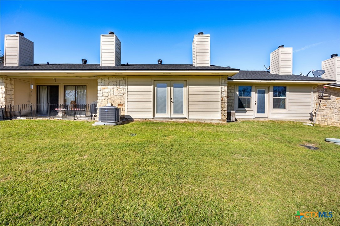 1015 Old Mill Road, Unit 4D Salado, TX 76571 - Photo 16 of 22 a front view of a house with a yard and palm trees