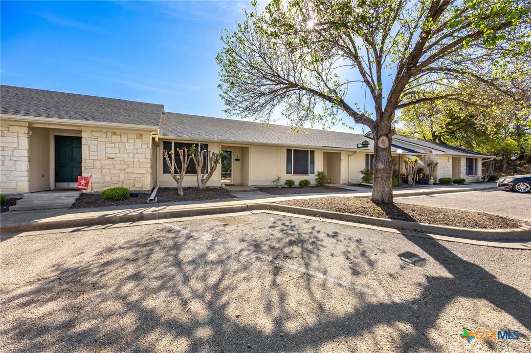 1015 Old Mill Road, Unit 4D Salado, TX 76571 - Photo 2 of 22 a house with trees in front of it