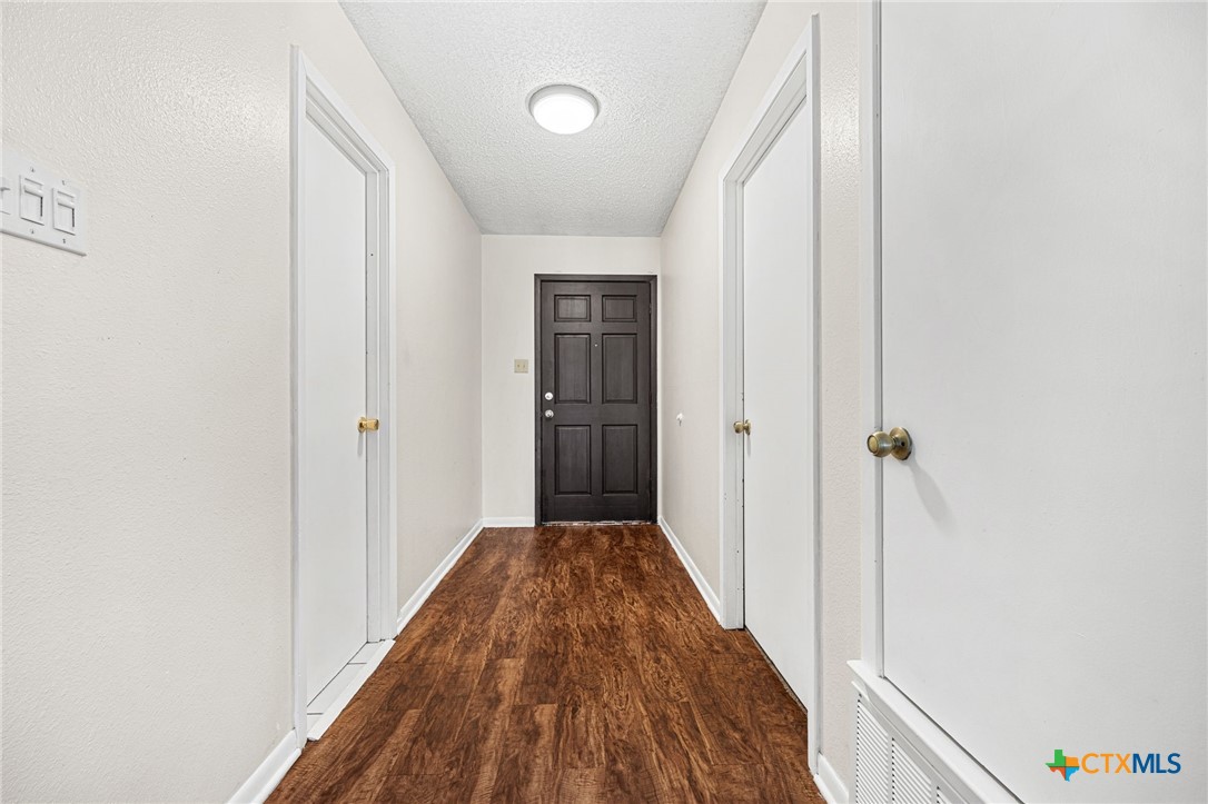 1015 Old Mill Road, Unit 4D Salado, TX 76571 - Photo 4 of 22 a view of a hallway with wooden floor and a bathroom