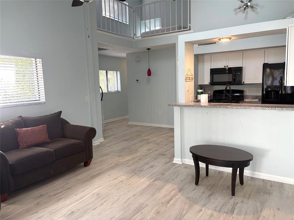 101 North Hill Avenue, Unit 7 Deland, FL 32724 - Photo 3 of 11 a living room with furniture and a wooden floor