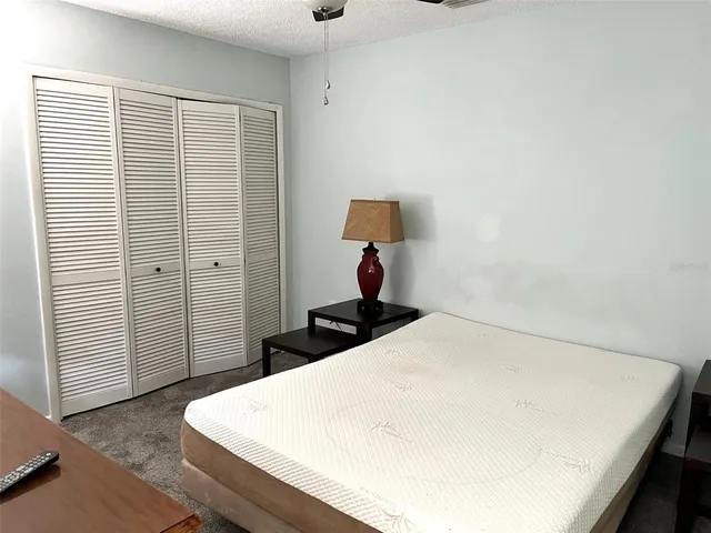 a bedroom with a bed and a night stand