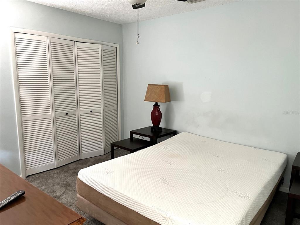101 North Hill Avenue, Unit 7 Deland, FL 32724 - Photo 5 of 11 a bedroom with a bed and a night stand