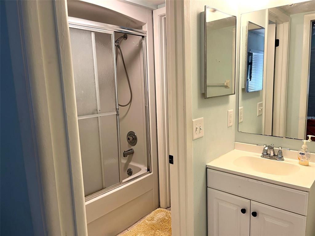 101 North Hill Avenue, Unit 7 Deland, FL 32724 - Photo 6 of 11 a bathroom with a granite countertop shower mirror and a sink