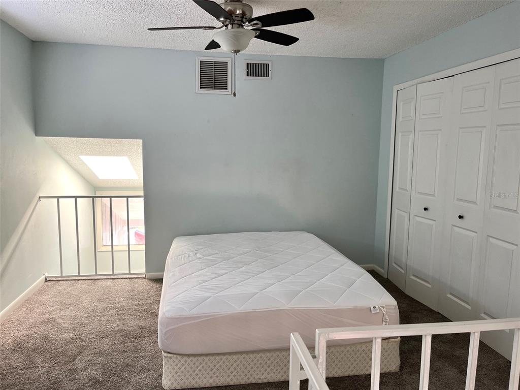 101 North Hill Avenue, Unit 7 Deland, FL 32724 - Photo 8 of 11 a bedroom with a bed and a window