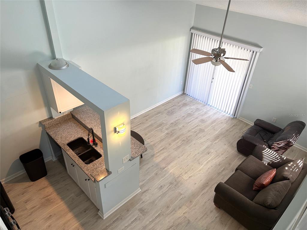 101 North Hill Avenue, Unit 7 Deland, FL 32724 - Photo 10 of 11 a living room with furniture and a wooden floor