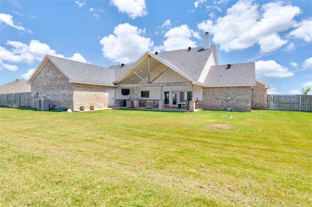 120 Long Ranger Road Abilene, TX 79602 - Photo 22 of 23 Expansive rear exterior featuring a covered patio with an exposed beam vaulted ceiling