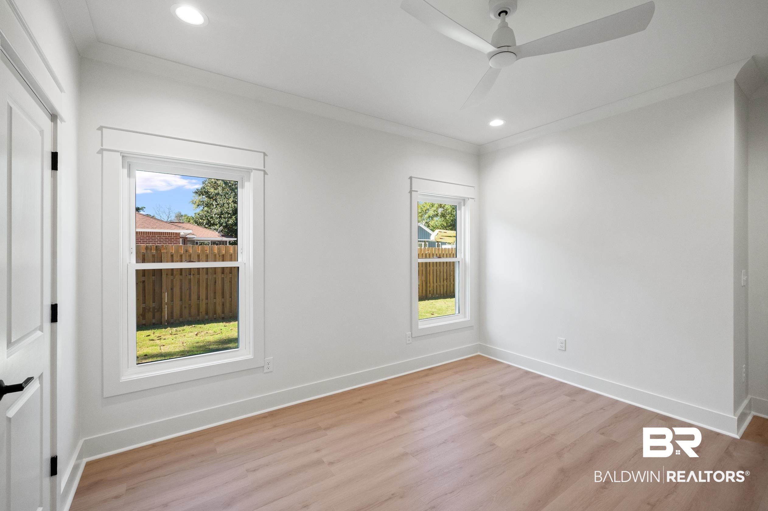 28889 Canal Road Orange Beach, AL 36561 - Photo 26 of 55 Empty room with ceiling fan, ornamental molding, and light wood-type flooring