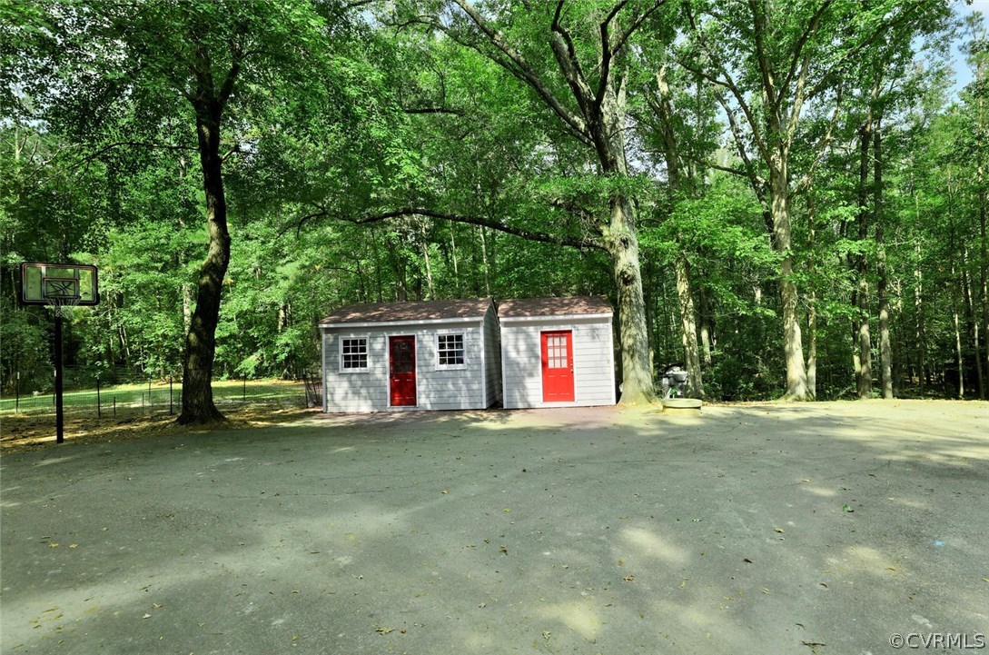 15900 Beach Road Chesterfield, VA 23838 - Photo 42 of 45 a view of a house with a backyard and trees
