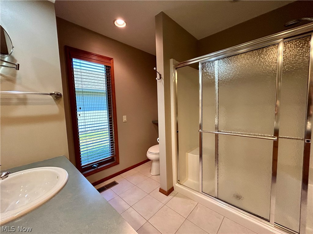 8763 Timber Edge Drive North Ridgeville, OH 44039 - Photo 19 of 40 Bathroom featuring tile floors, an enclosed shower, toilet, and vanity
