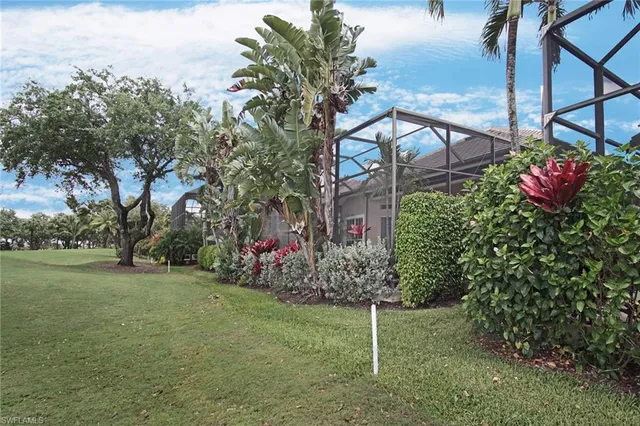 a view of a house with a big yard and potted plants