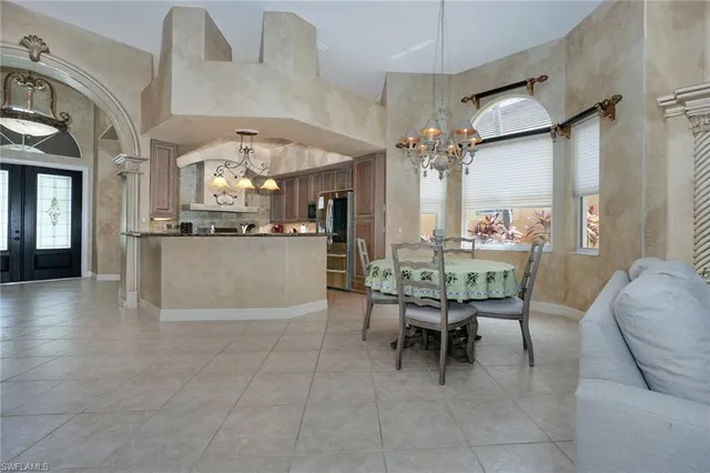 a view of a dining room with furniture and chandelier