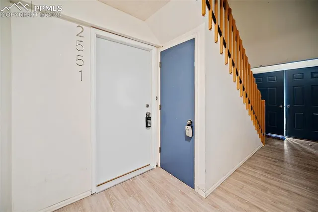 a view of empty room with cabinet and wooden floor