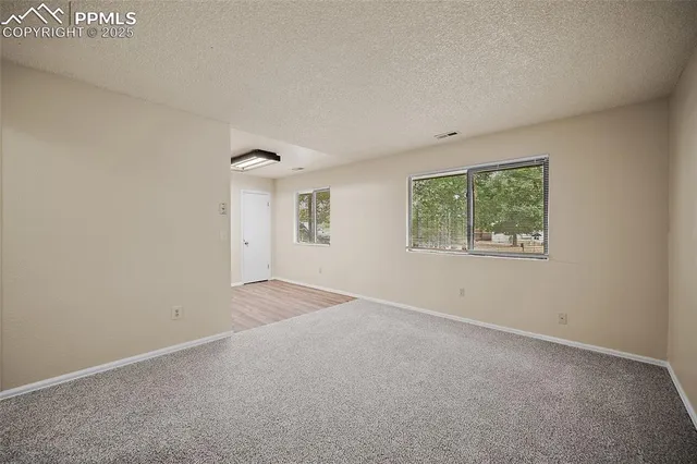 a kitchen with stainless steel appliances white cabinets and wooden floors