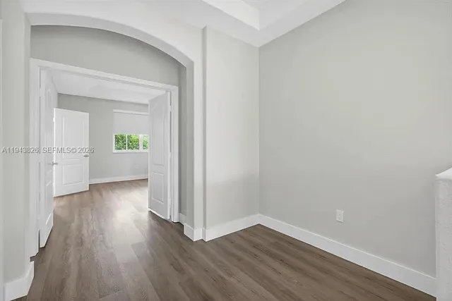 a view of wooden floor and windows in an empty room