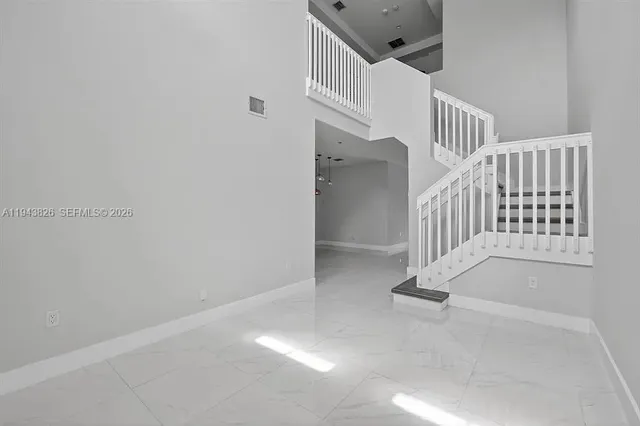 a view of staircase with white walls and windows