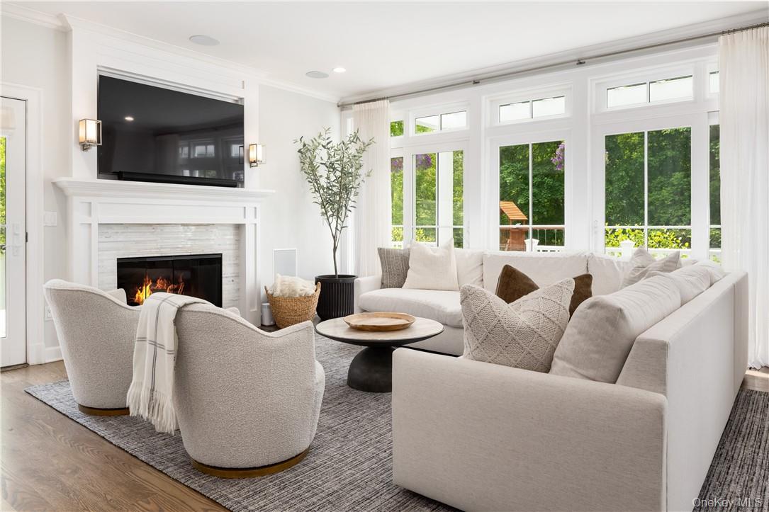 56 Intervale Place Rye, NY 10580 - Photo 9 of 29 a living room with furniture a fireplace and a flat screen tv