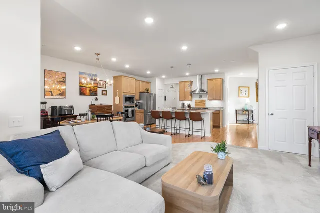 a living room with furniture and kitchen view
