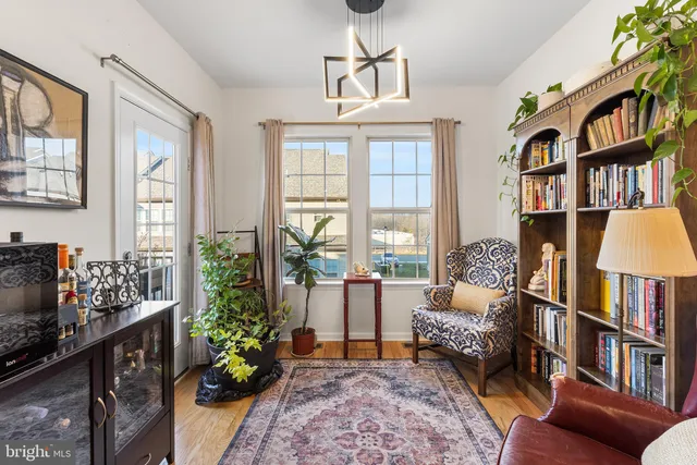 a living room with furniture and a book shelf