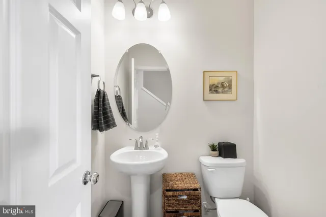 a bathroom with a toilet a sink and mirror