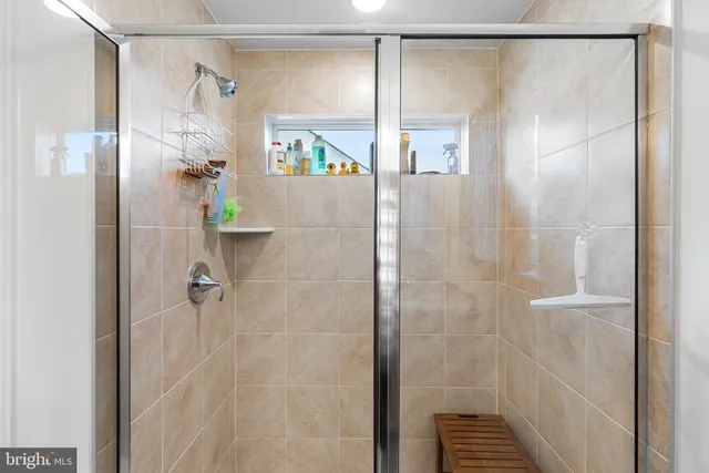 a bathroom with a glass shower door