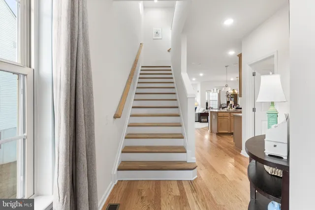 a view of entryway and hall with wooden floor