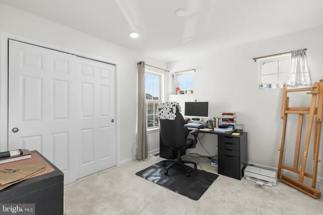 a view of a workspace with furniture and a workspace