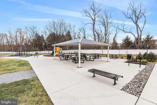 a view of a swimming pool with a patio and a yard