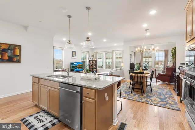 a kitchen with a stove and a wooden floor