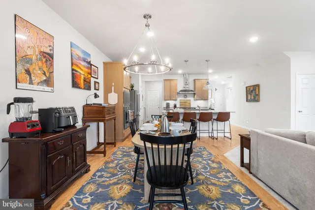a view of a dining room with furniture and chandelier