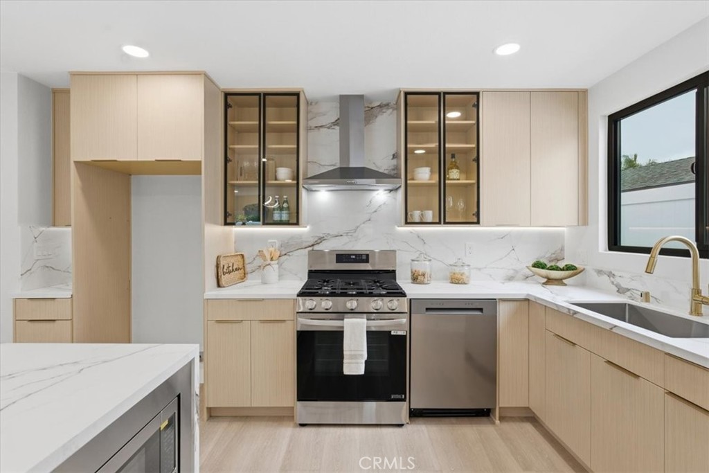 168 226th Street Carson, CA 90745 - Photo 11 of 40 a kitchen with a stove top oven sink and window