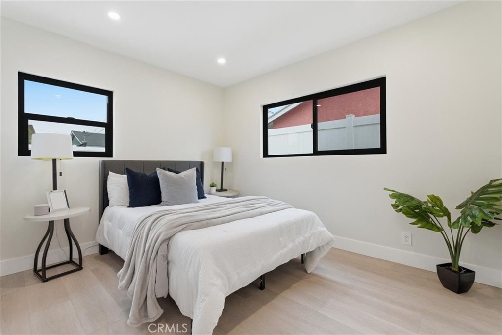 168 226th Street Carson, CA 90745 - Photo 19 of 40 a bedroom with bed and a potted plant