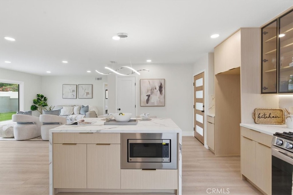 168 226th Street Carson, CA 90745 - Photo 2 of 40 a kitchen with stainless steel appliances kitchen island granite countertop a refrigerator and a stove top oven