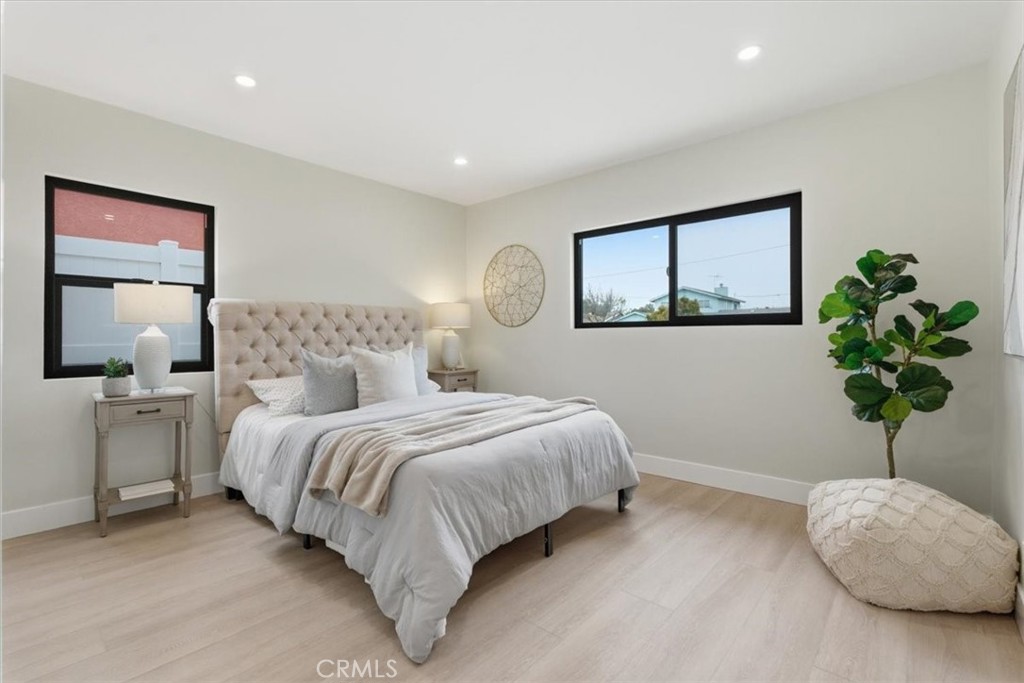 168 226th Street Carson, CA 90745 - Photo 21 of 40 a bedroom with bed and a potted plant