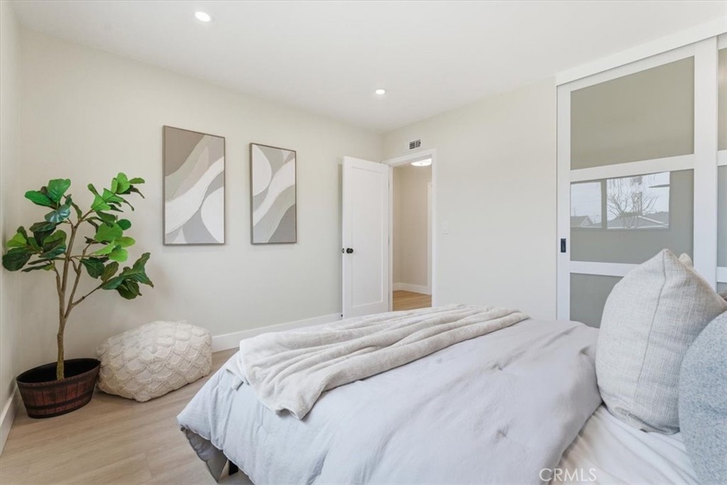 168 226th Street Carson, CA 90745 - Photo 22 of 40 a bedroom with a bed and a potted plant