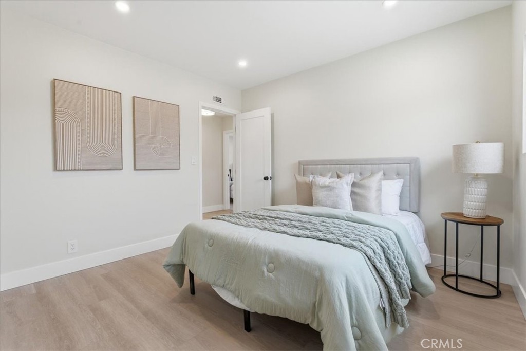168 226th Street Carson, CA 90745 - Photo 23 of 40 a bedroom with a bed and a lamp