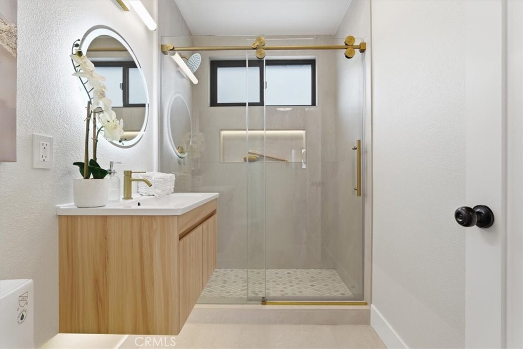 168 226th Street Carson, CA 90745 - Photo 3 of 40 a bathroom with a sink a mirror and shower