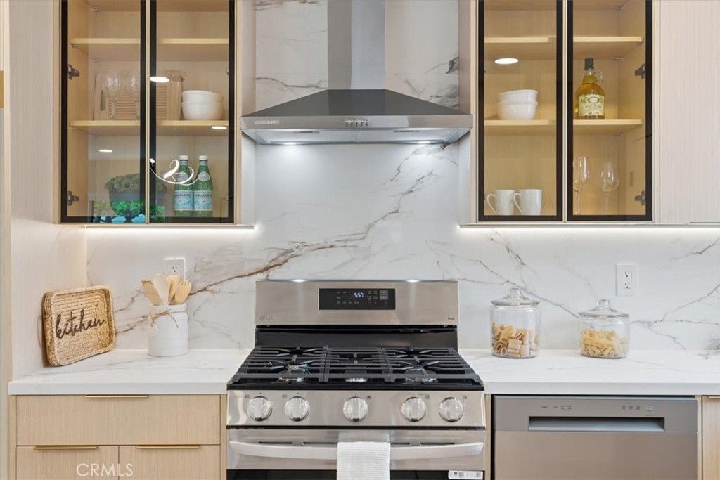 168 226th Street Carson, CA 90745 - Photo 4 of 40 a kitchen with stainless steel appliances granite countertop a stove and a refrigerator
