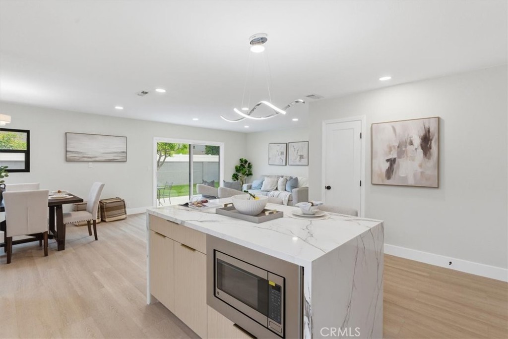 168 226th Street Carson, CA 90745 - Photo 8 of 40 a view of a kitchen area with furniture and wooden floor