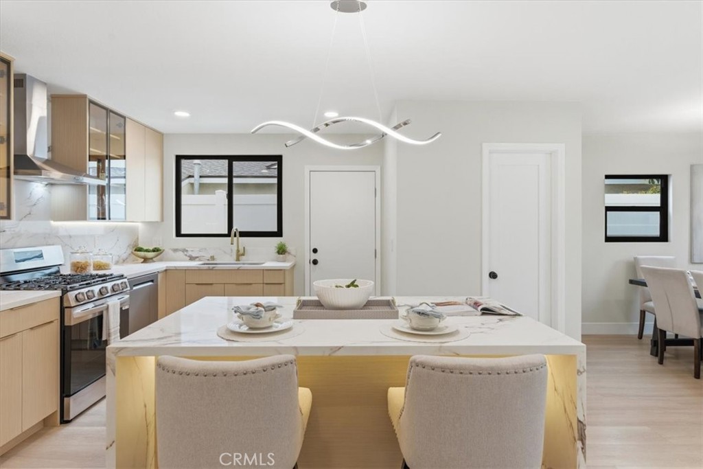 168 226th Street Carson, CA 90745 - Photo 9 of 40 a kitchen with a sink stove and cabinets