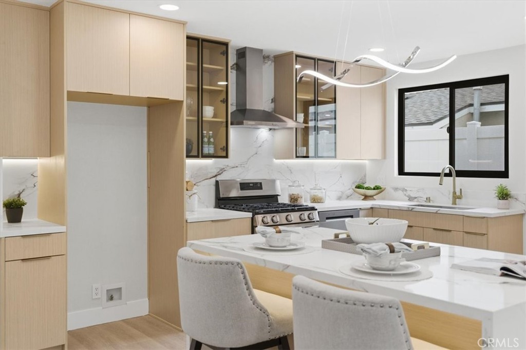 168 226th Street Carson, CA 90745 - Photo 10 of 40 a kitchen with stainless steel appliances granite countertop a sink and a stove next to a window