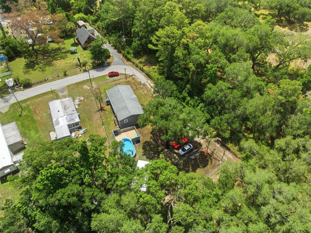 3183 Cedley Road Dade City, FL 33523 - Photo 38 of 48 an aerial view of a house with a yard and large trees