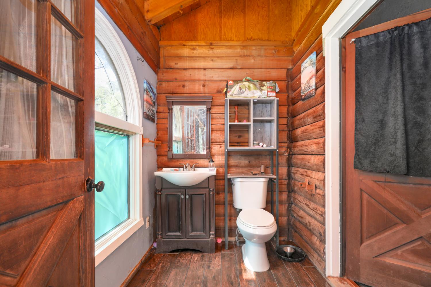 12661 Krosens Road Marysville, CA 95901 - Photo 15 of 79 a bathroom with a toilet a sink and a large window