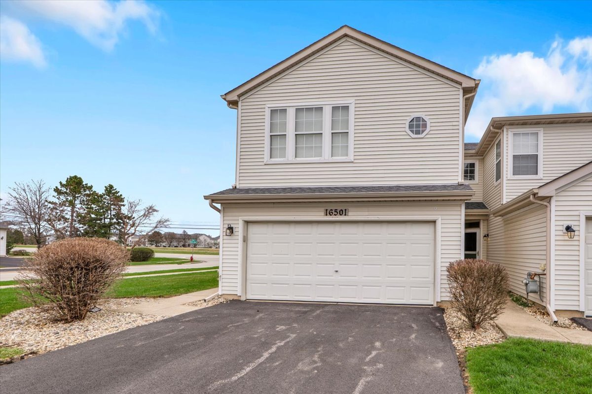 16501 Nottingham Court Lockport, IL 60441 - Photo 2 of 44 a front view of a house with a yard and garage