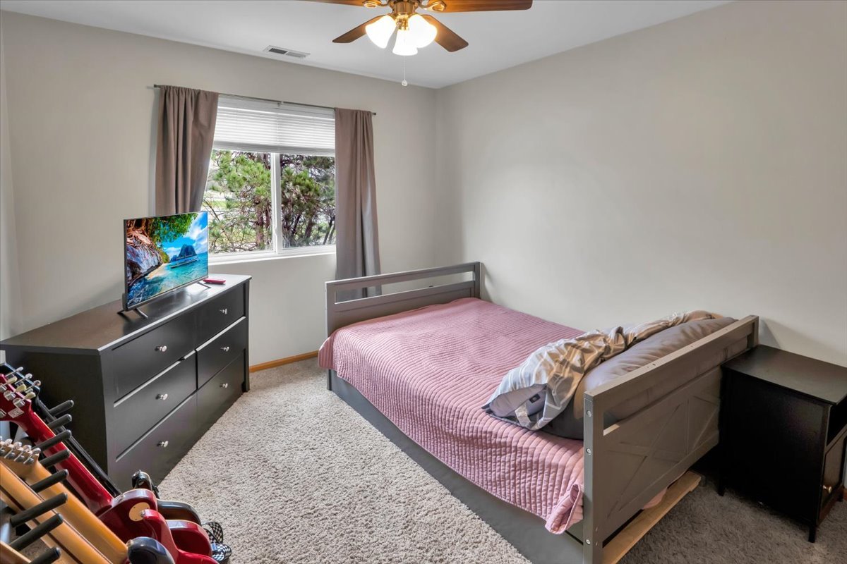 16501 Nottingham Court Lockport, IL 60441 - Photo 21 of 44 a bed sitting in a bedroom next to a window