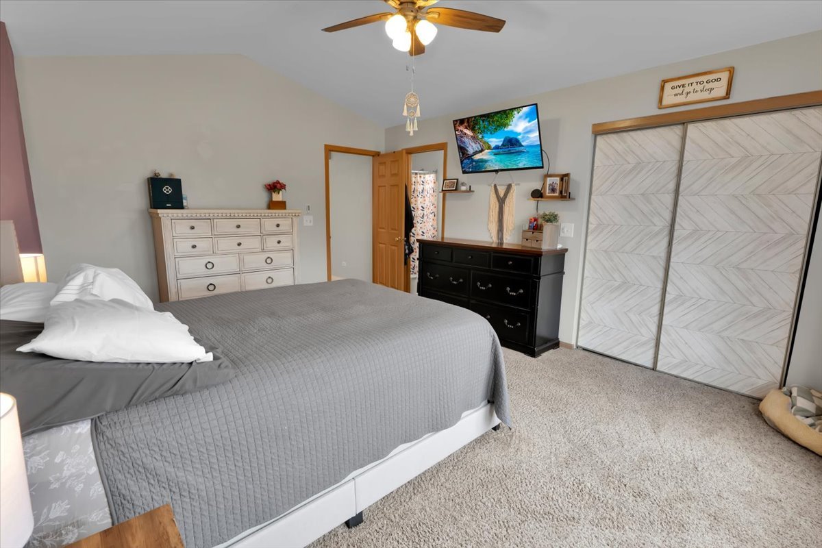 16501 Nottingham Court Lockport, IL 60441 - Photo 27 of 44 a bedroom with a bed and a chandelier