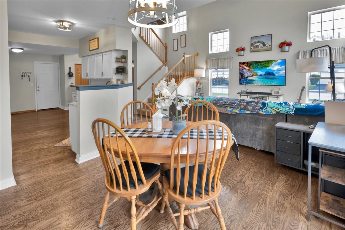 16501 Nottingham Court Lockport, IL 60441 - Photo 10 of 44 a view of a dining room with furniture a chandelier and wooden floor
