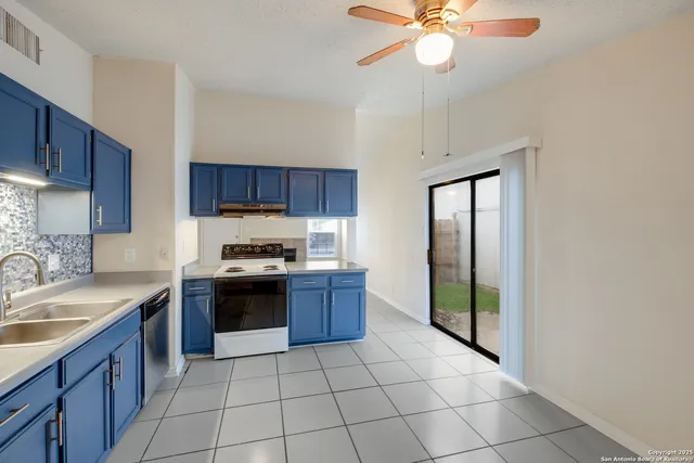 a kitchen with stainless steel appliances granite countertop a stove sink and cabinets