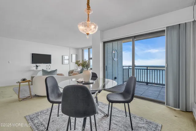 a living room with furniture a chandelier and a flat screen tv