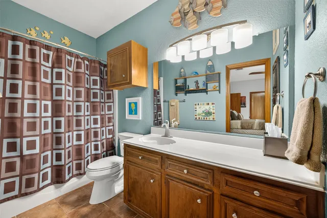 a spacious bedroom with a large bed and a large window